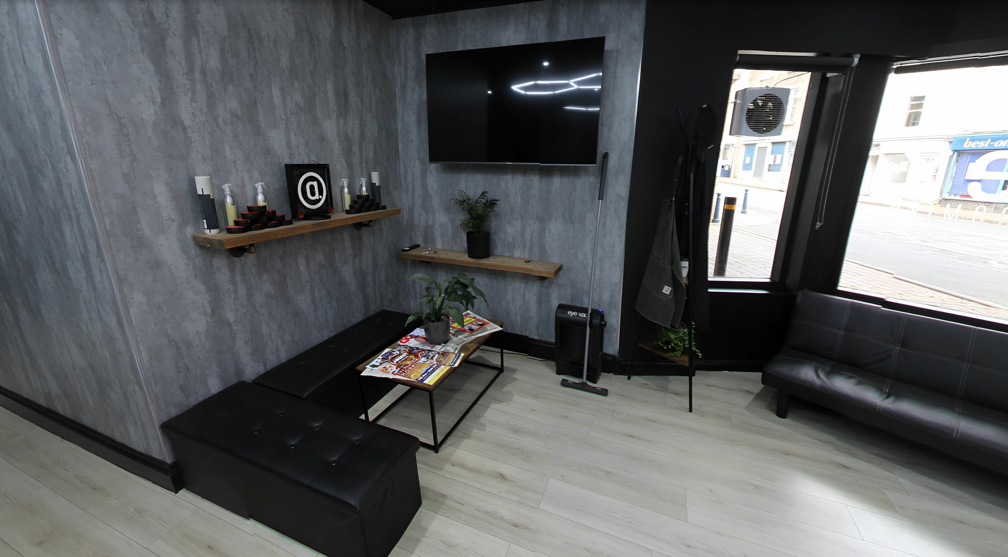 Chic lounge area in Apex Male Grooming, Morpeth, England, GB, featuring sleek seating and decor.