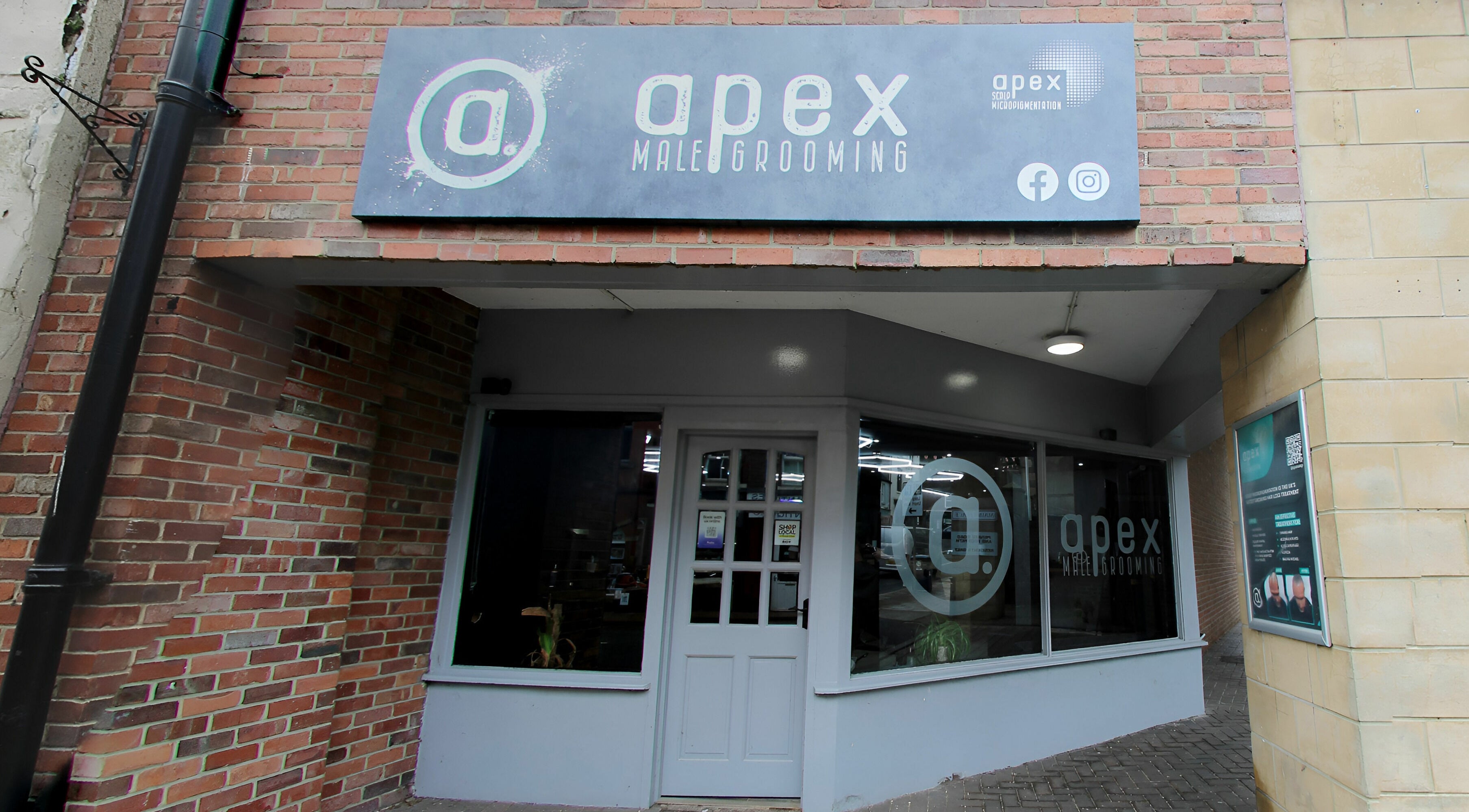 Entrance of Apex Male Grooming located in Morpeth, England, GB, showcasing modern style and branding.