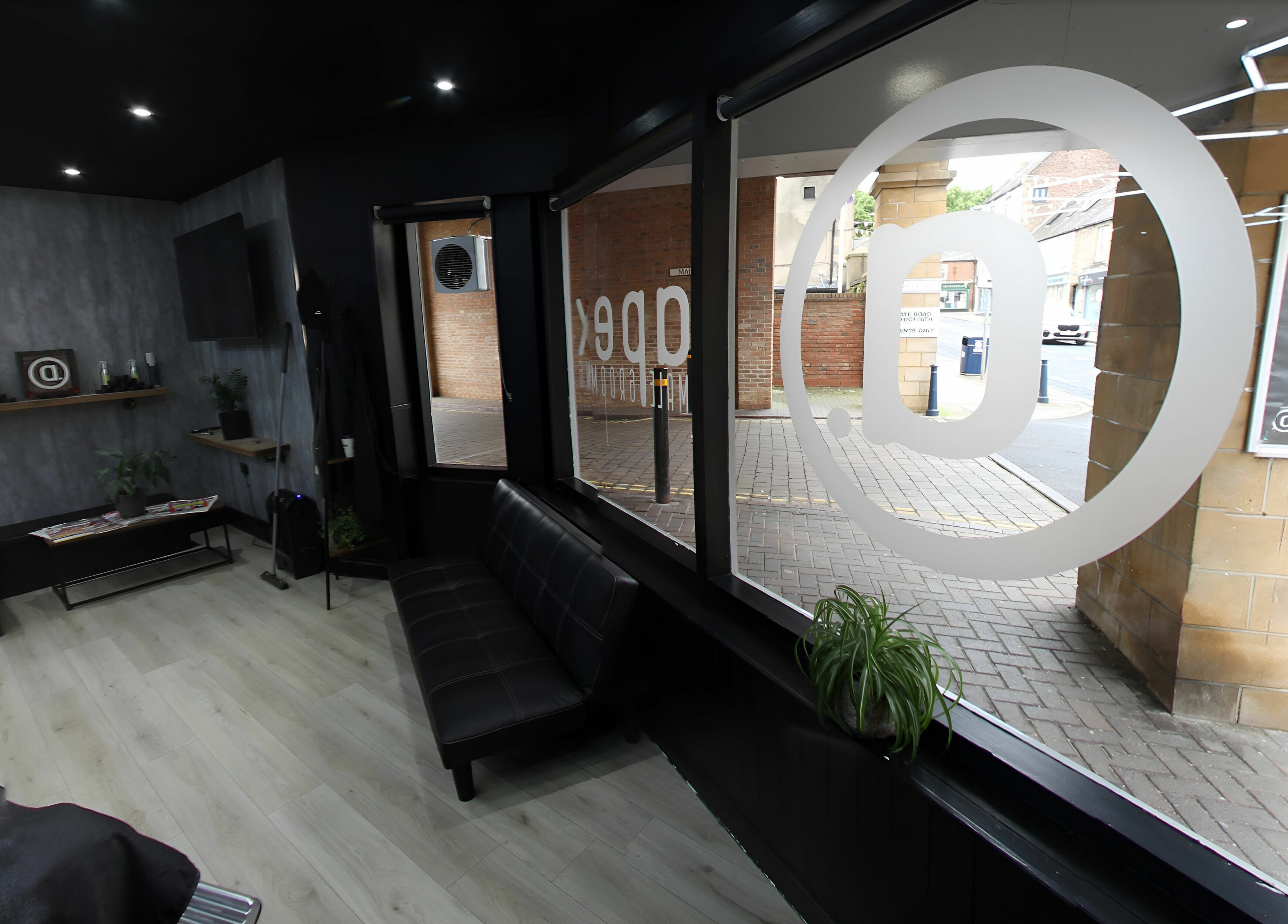 Sleek interior of Apex Male Grooming in Morpeth, England, GB showcasing contemporary design and seating.