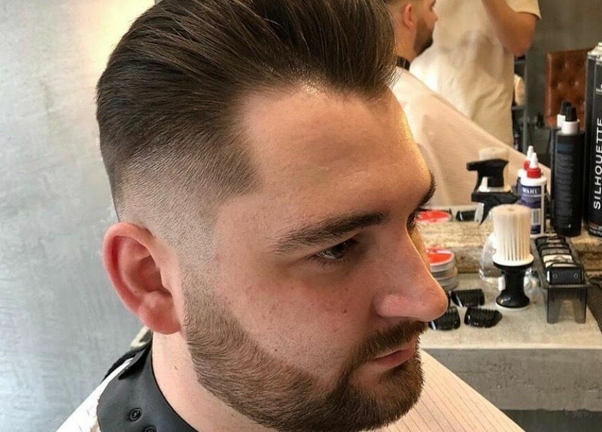 Close-up of a stylish fade haircut at Apex Male Grooming, Morpeth, England, GB, featuring sleek barber tools.