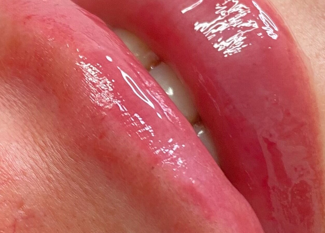 Close-up of glossy lips treated at JCandy Beauty Services, rebranding to Nadra Beauty soon, in Birmingham, England, GB.