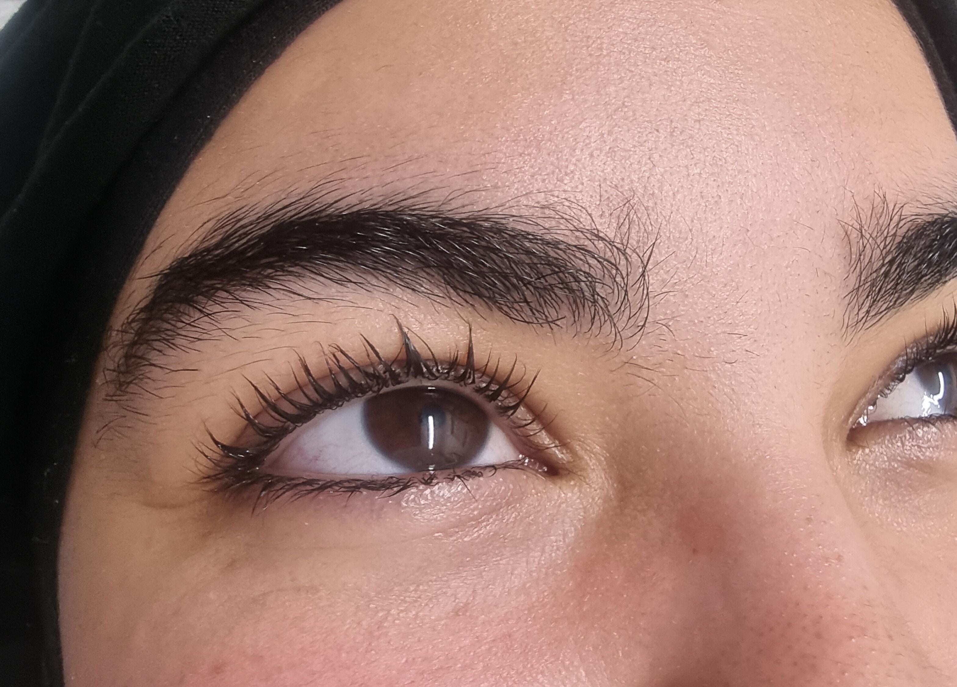 Close-up of well-groomed eyebrows and curled lashes at JCandy Beauty Services, Birmingham, England, GB.