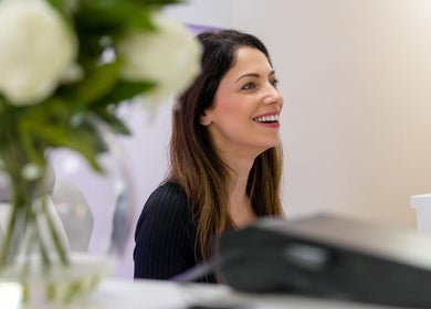 Smiling receptionist at Bianco Beauty Milton Keynes, Milton Keynes, England, GB with elegant decor.