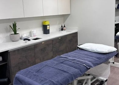 Cozy treatment room at Bianco Beauty Soho, London, England, GB with a comfortable massage table and modern decor.