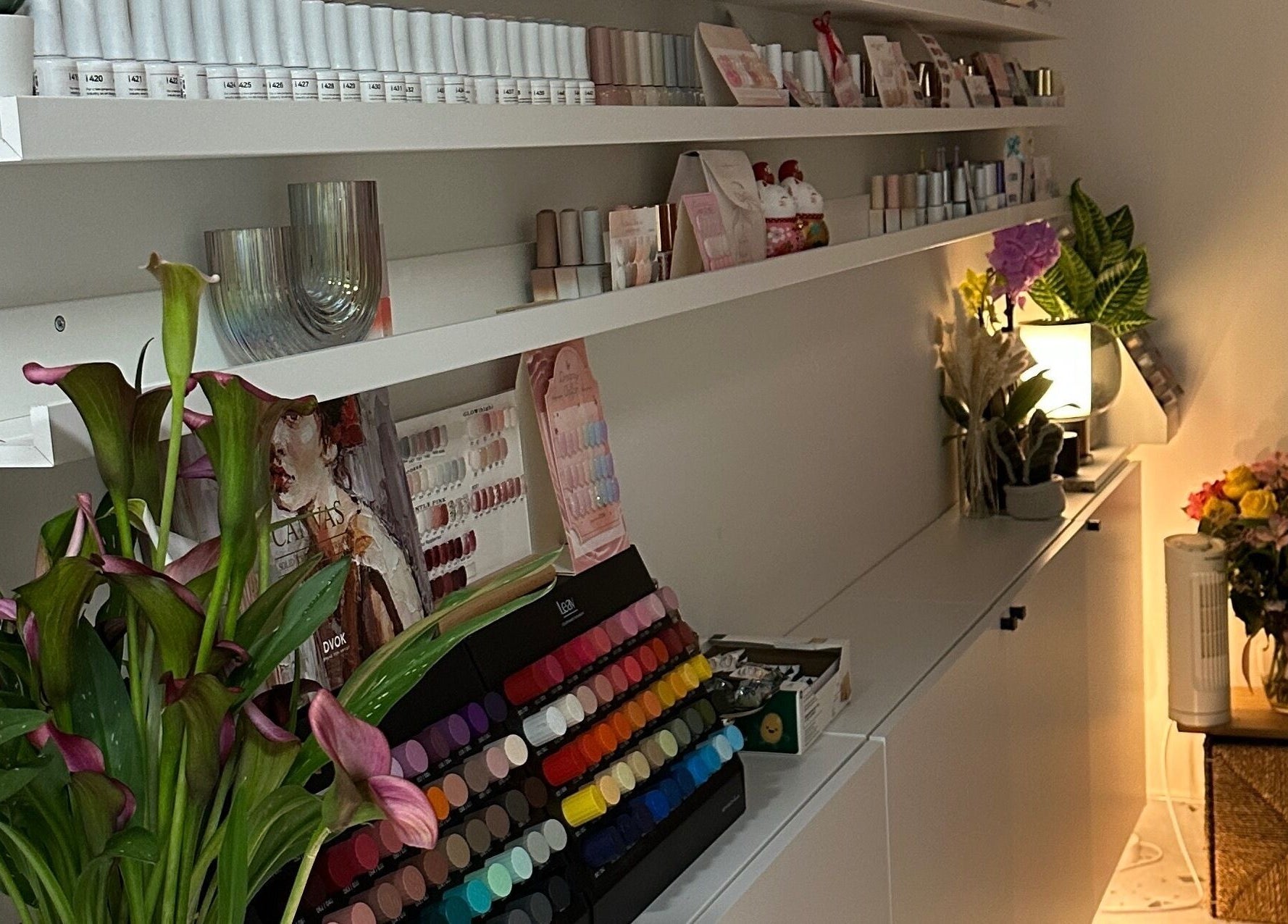 Elegant nail polish display at Jennie Nail Studio, Markham, Ontario, CA, surrounded by plants and decor.