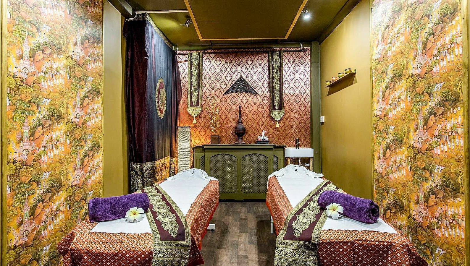 Tranquil massage room at Wanida Thai Spa Ltd, London, England, GB featuring lush decor and dual treatment beds.