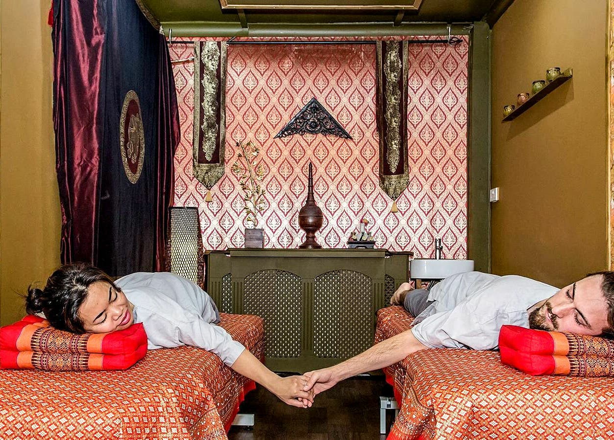 Couple holding hands during Thai massage at Wanida Thai Spa Ltd, London, England, GB.