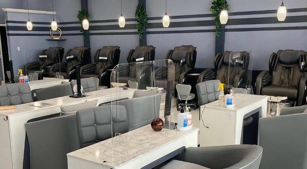 Elegant nail salon interior at Forever Nails, Indian Harbour Beach, Florida, US, featuring comfortable chairs and tables.