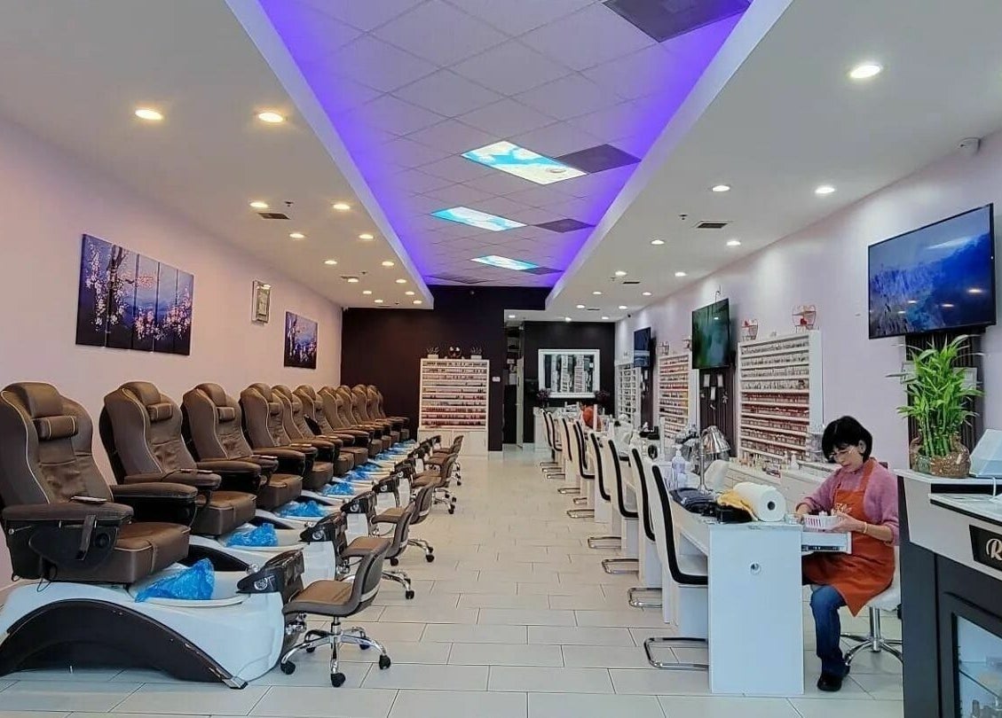 Interior of Gloss and Feathers (Nails. Lashes. Wax.) in Phoenix, Arizona, US, showing elegant seating and decor.