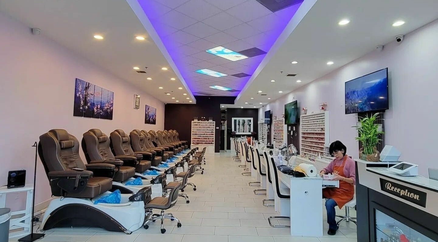 Interior of Gloss and Feathers (Nails. Lashes. Wax.) in Phoenix, Arizona, US, showing elegant seating and decor.