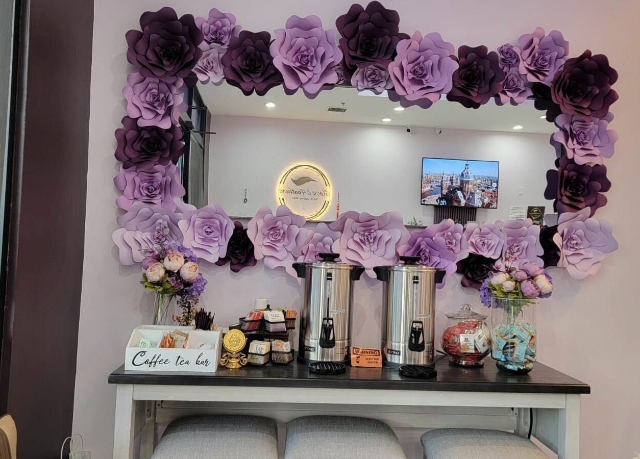 Gloss and Feathers (Nails. Lashes. Wax.) in Phoenix, Arizona, US features a floral mirror and coffee bar setup.
