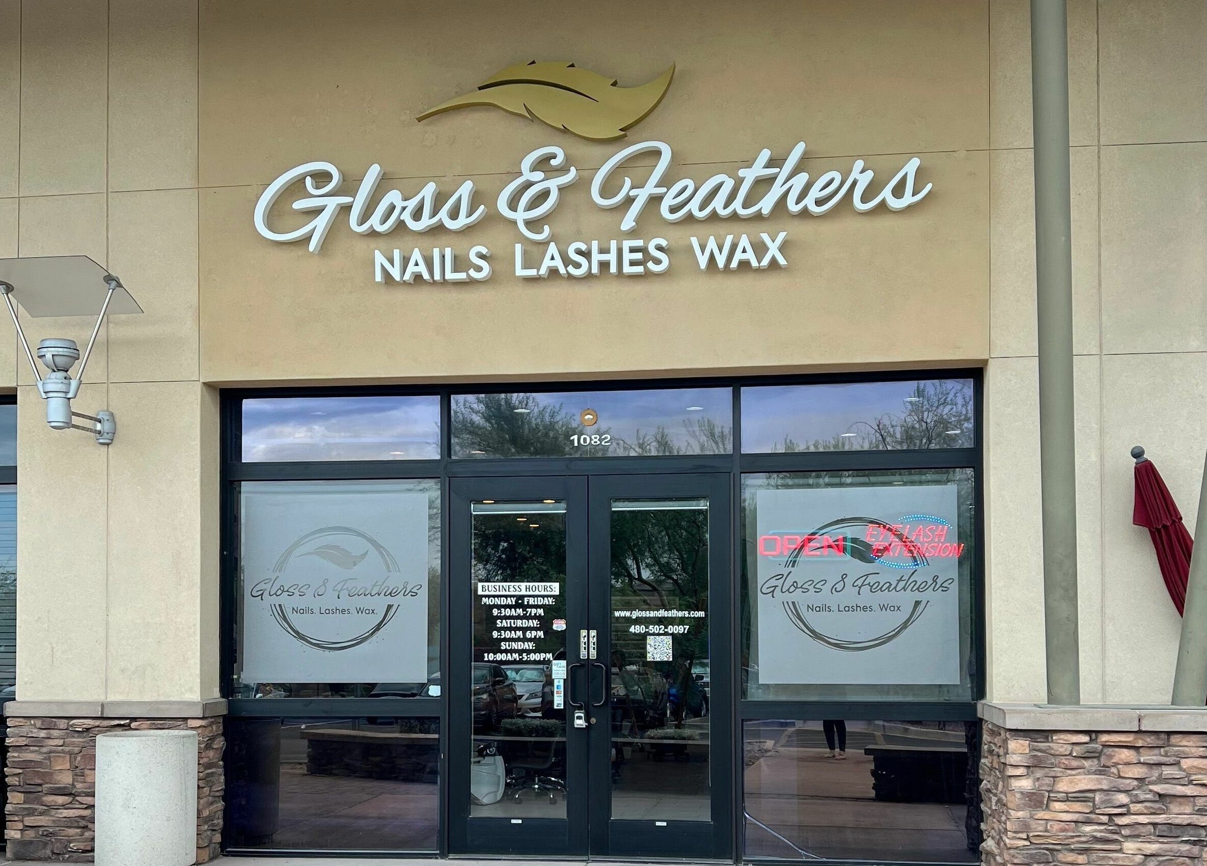 Entrance of Gloss and Feathers (Nails. Lashes. Wax.) in Phoenix, Arizona, US, showcasing modern storefront signage.