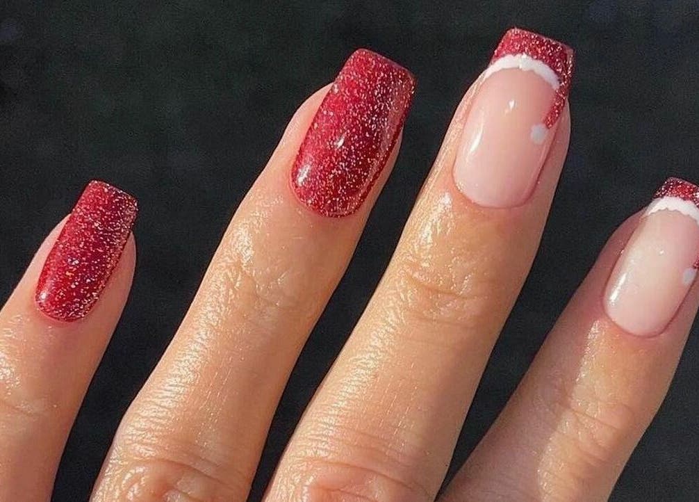 Red glitter nails at Gloss and Feathers (Nails. Lashes. Wax.) in Phoenix, Arizona, US, offering chic designs.