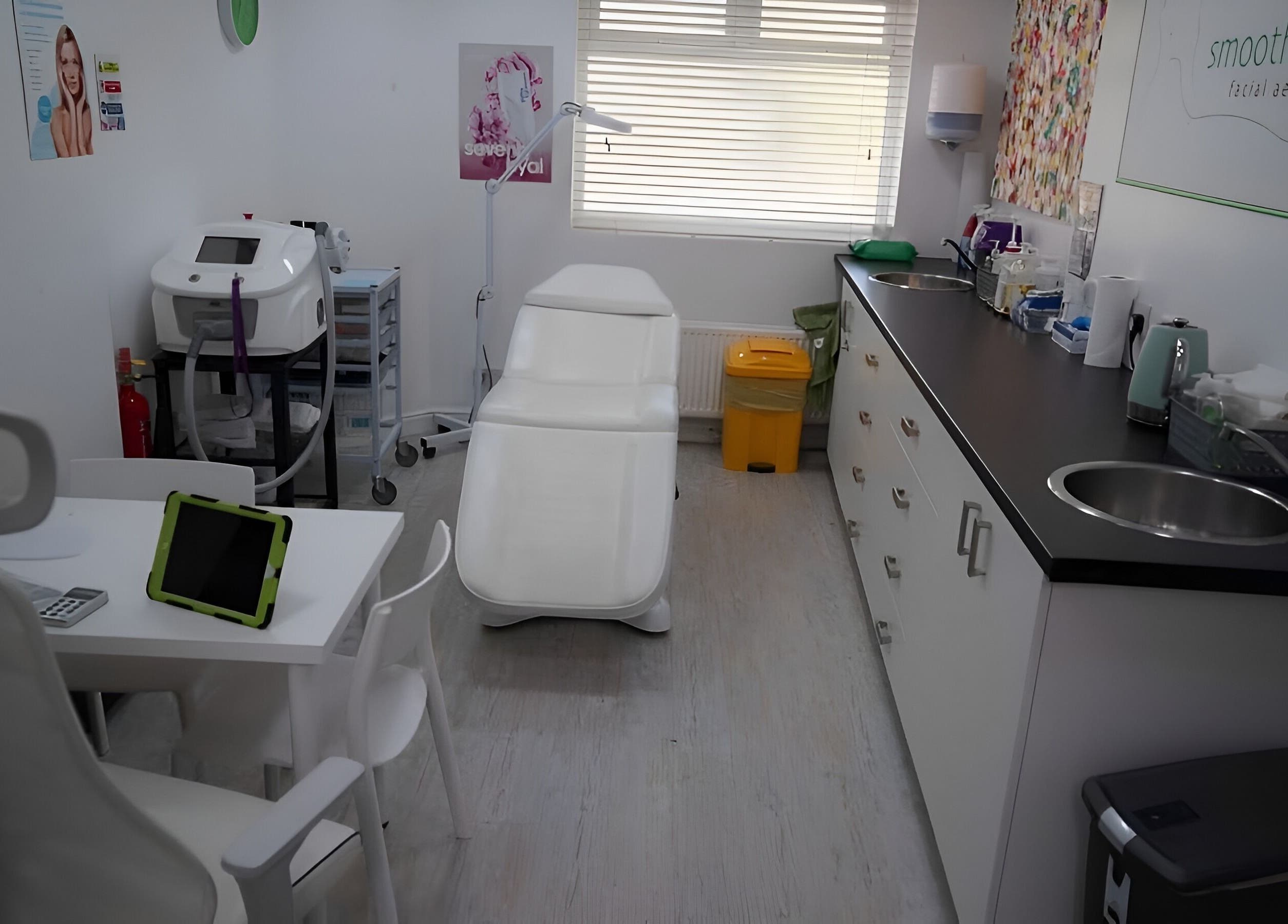 Smoothlines Facial Aesthetics treatment room in Stockport, England, GB featuring modern equipment and soothing decor.