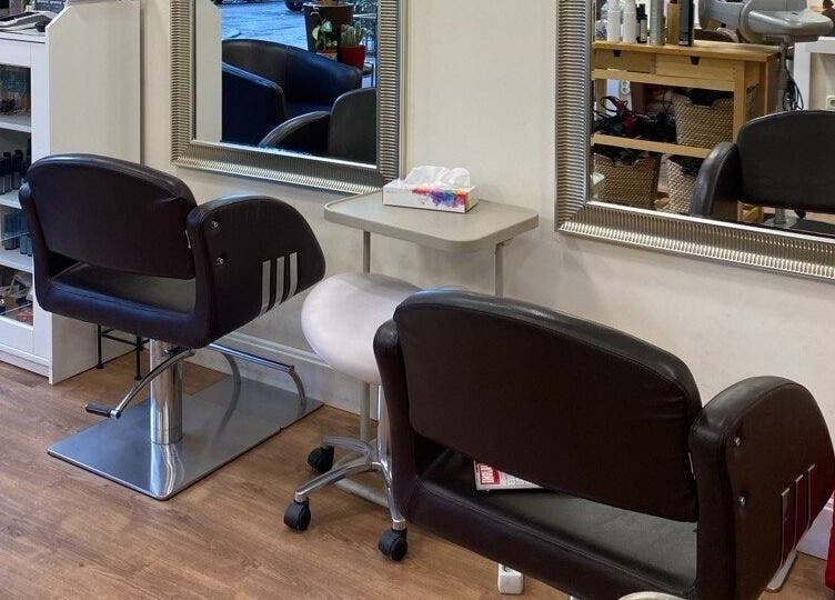Interior moderno de Rytuals Peluqueros en Madrid, Comunidad de Madrid, ES, con sillas de peluquería y espejos.