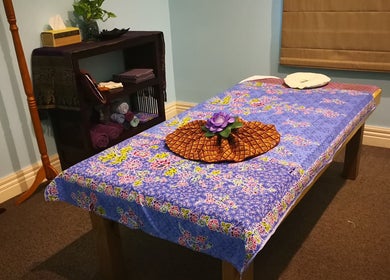 Relaxing massage room at Surin Thai Spa, Auckland, Auckland, NZ, with floral decor and calming ambiance.