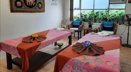 Serene massage room at Surin Thai Spa, Auckland, NZ with two decorated tables.