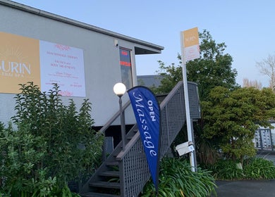 Entrance of Surin Thai Spa in Auckland, NZ, with signage and greenery.