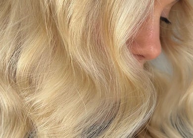 Blonde hair with soft curls at Harpar Hair, East Geelong, Victoria, AU, showcasing salon's styling expertise.