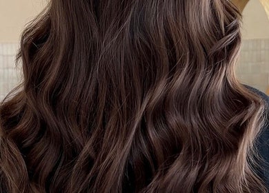 Elegant wavy hairstyle at Harpar Hair in East Geelong, Victoria, AU, showcasing rich brunette shades.