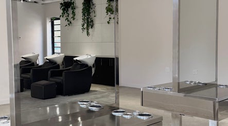 Modern wash stations at Honeycomb Hair Lounge, Regina, Saskatchewan, CA, featuring sleek design and greenery.