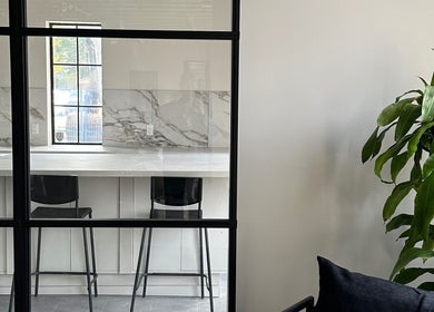 Modern interior of Honeycomb Hair Lounge in Regina, Saskatchewan, CA with marble accents and greenery.