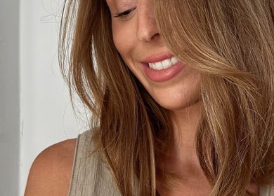 Smiling woman with styled hair at Honeycomb Hair Lounge, Regina, Saskatchewan, CA.