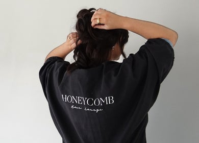 Back view of a client preparing hair at Honeycomb Hair Lounge, Regina, Saskatchewan, CA.
