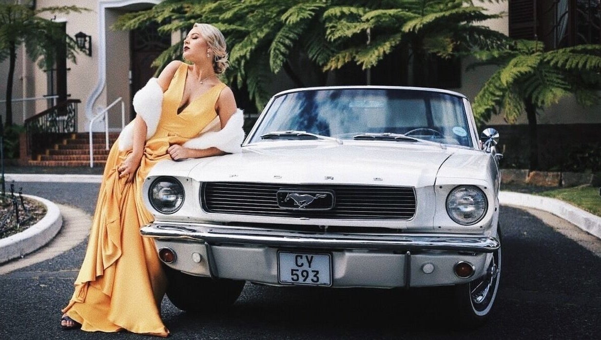 Sophisticated woman in yellow gown beside classic car at Go Brown Durbanville Studio, Durbanville, Western Cape, ZA.