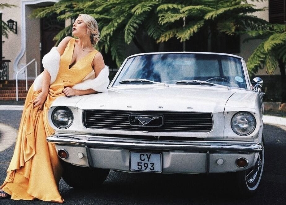 Sophisticated woman in yellow gown beside classic car at Go Brown Durbanville Studio, Durbanville, Western Cape, ZA.