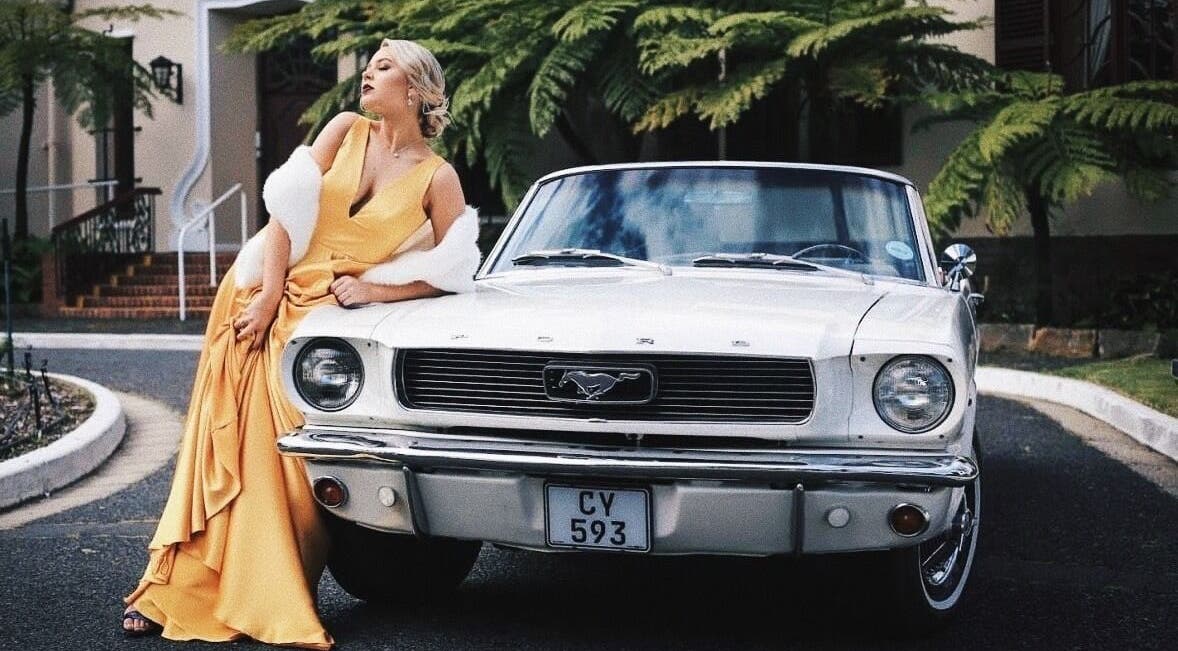 Sophisticated woman in yellow gown beside classic car at Go Brown Durbanville Studio, Durbanville, Western Cape, ZA.