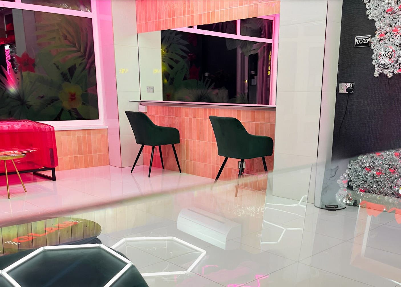 Chic interior of That Glam Bar Goring by Sea, Worthing, England, GB showcasing plush seating and neon decor.