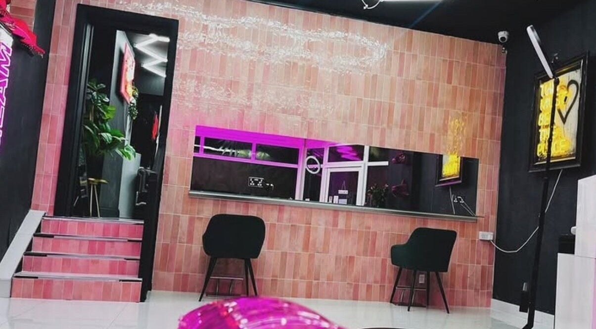 Modern interior of That Glam Bar Goring by Sea, Worthing, England, GB with stylish seating and neon lights.