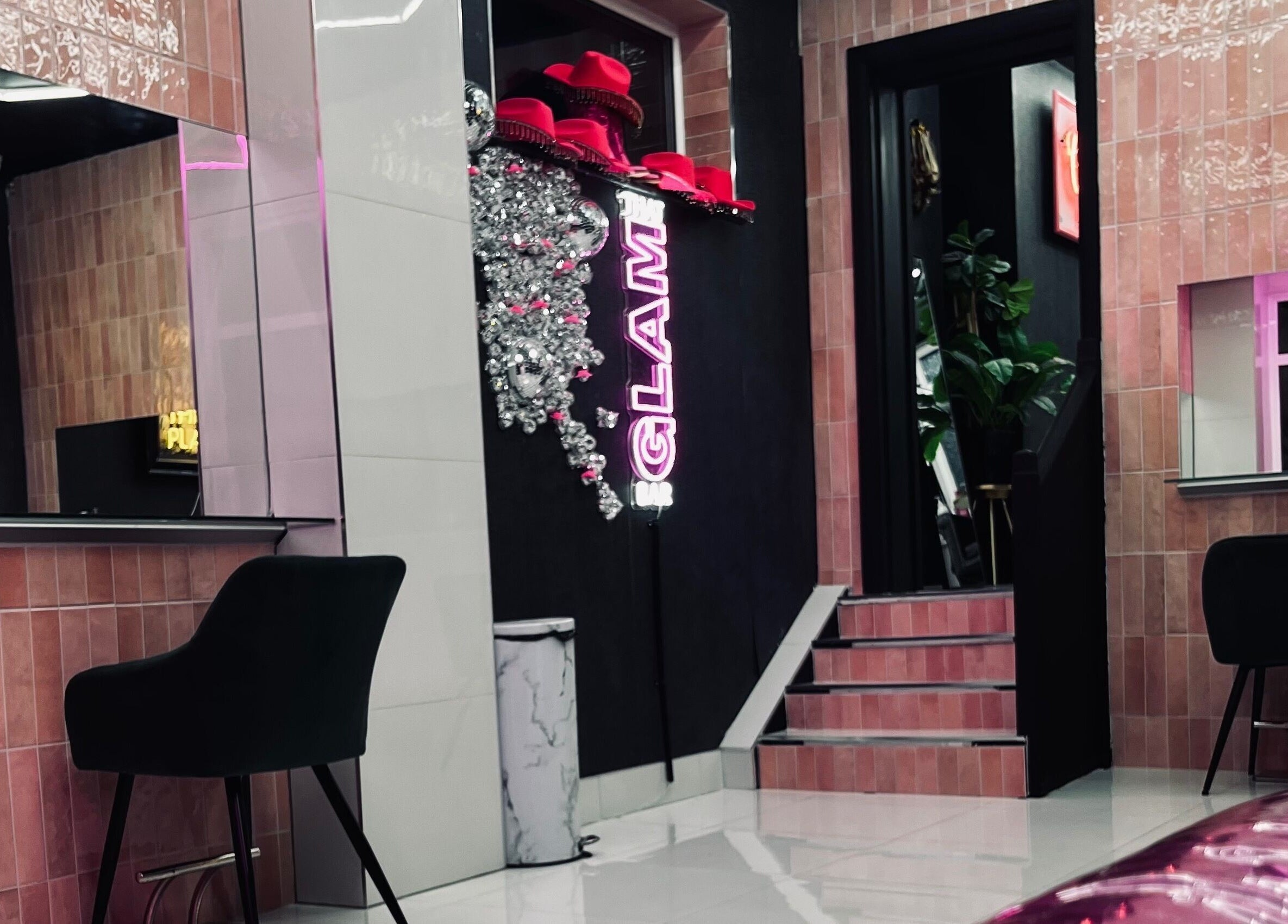 Interior view of That Glam Bar Goring by Sea in Worthing, England, GB, showcasing modern decor and neon accents.