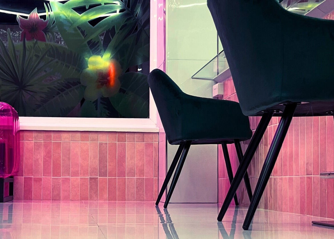 Stylish interior of That Glam Bar Goring by Sea in Worthing, England, GB with modern pink and black decor.