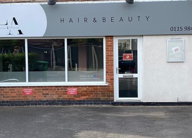 Front view of L&A Hairdressing and Beauty in Ruddington, England, GB with stylish signage and large window.
