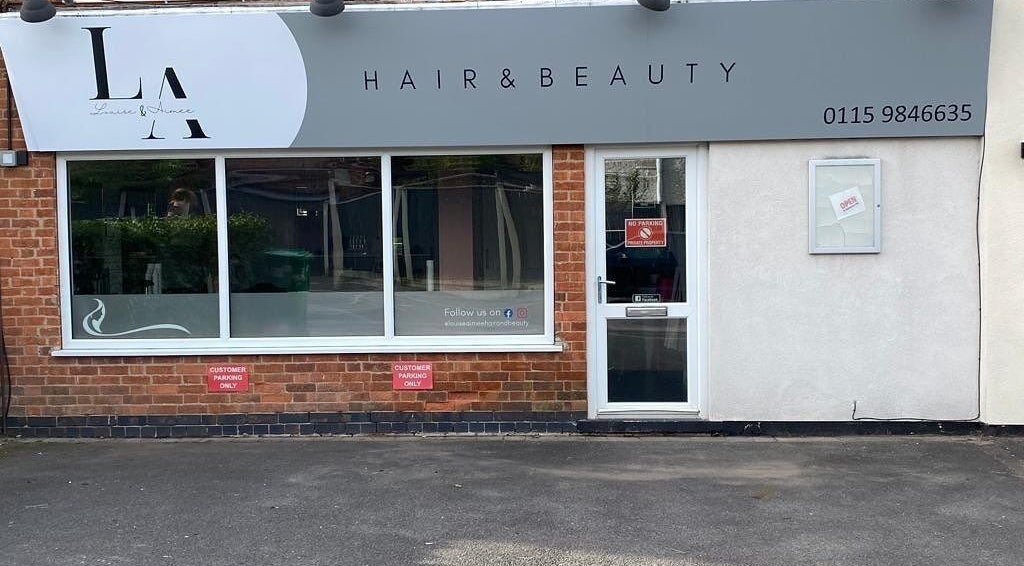 Front view of L&A Hairdressing and Beauty in Ruddington, England, GB with stylish signage and large window.