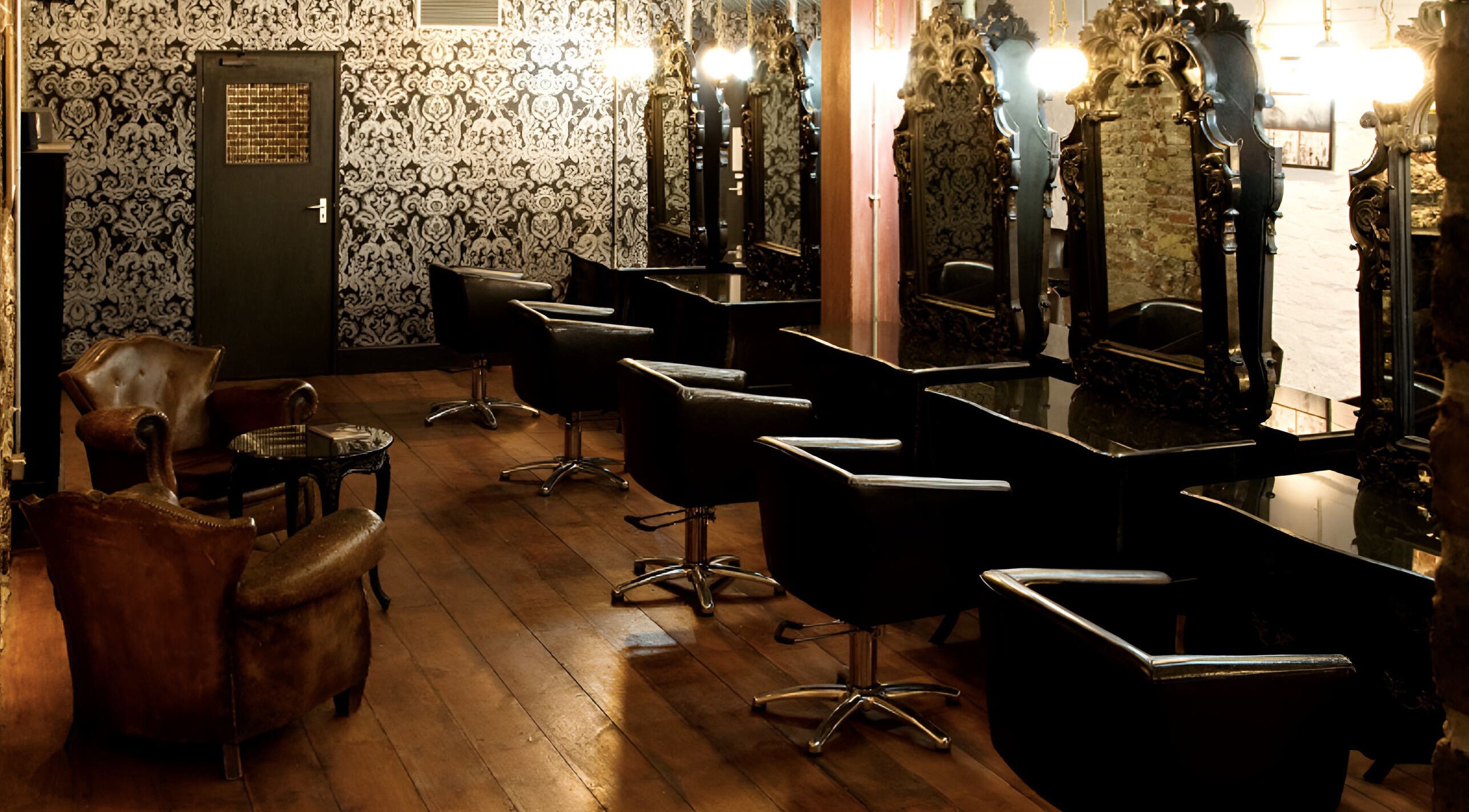 Elegant interior of Hayato London salon in London, England, GB with chic mirrors and leather chairs.