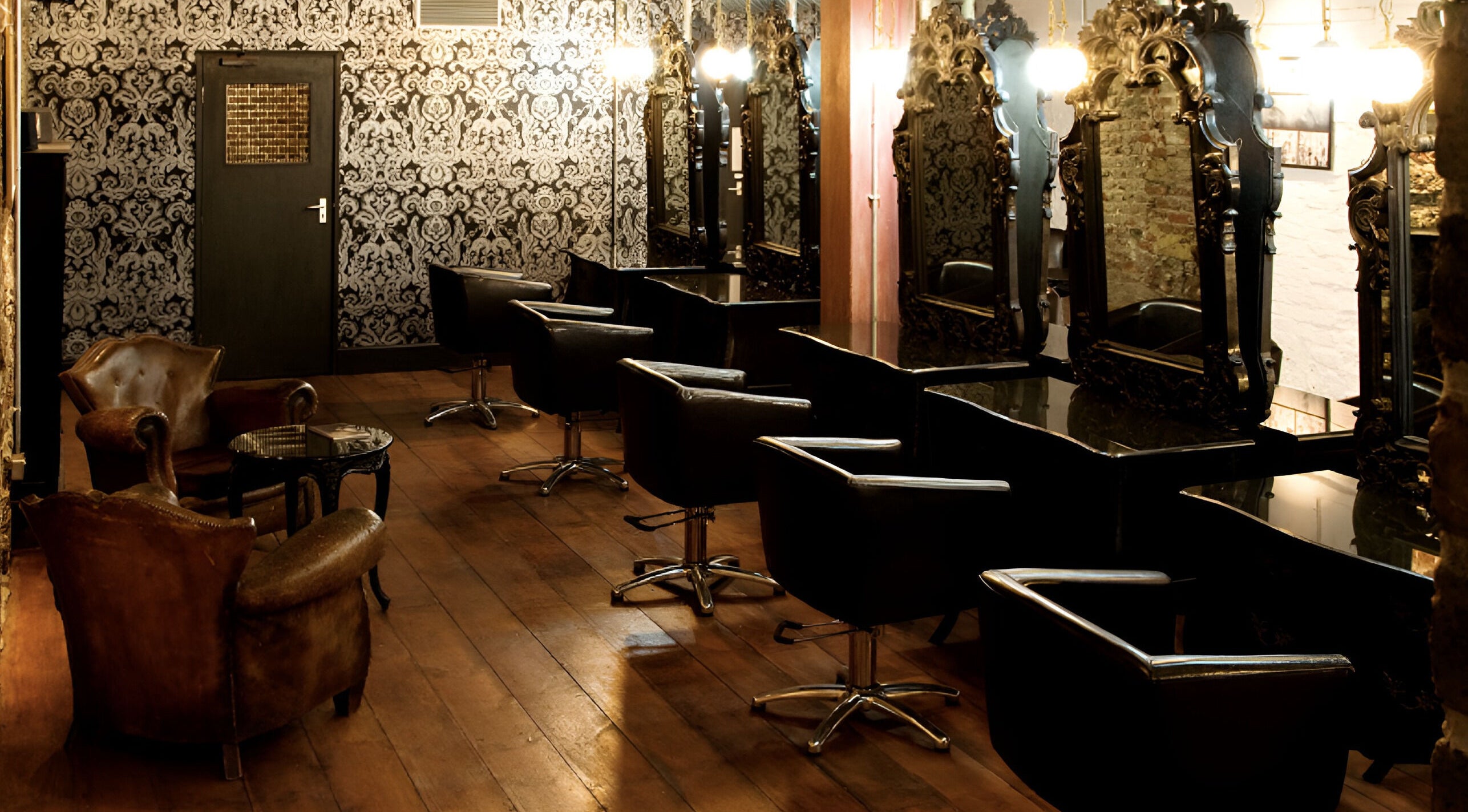 Elegant interior of Hayato London salon in London, England, GB with chic mirrors and leather chairs.