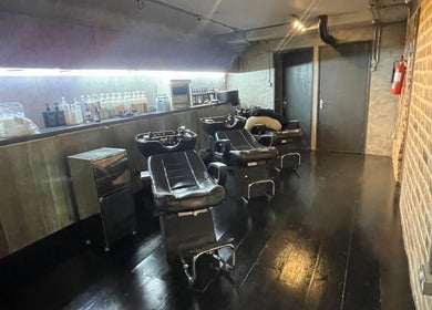 Stylish salon wash stations at Hayato London, located in London, England, GB, featuring sleek black chairs.