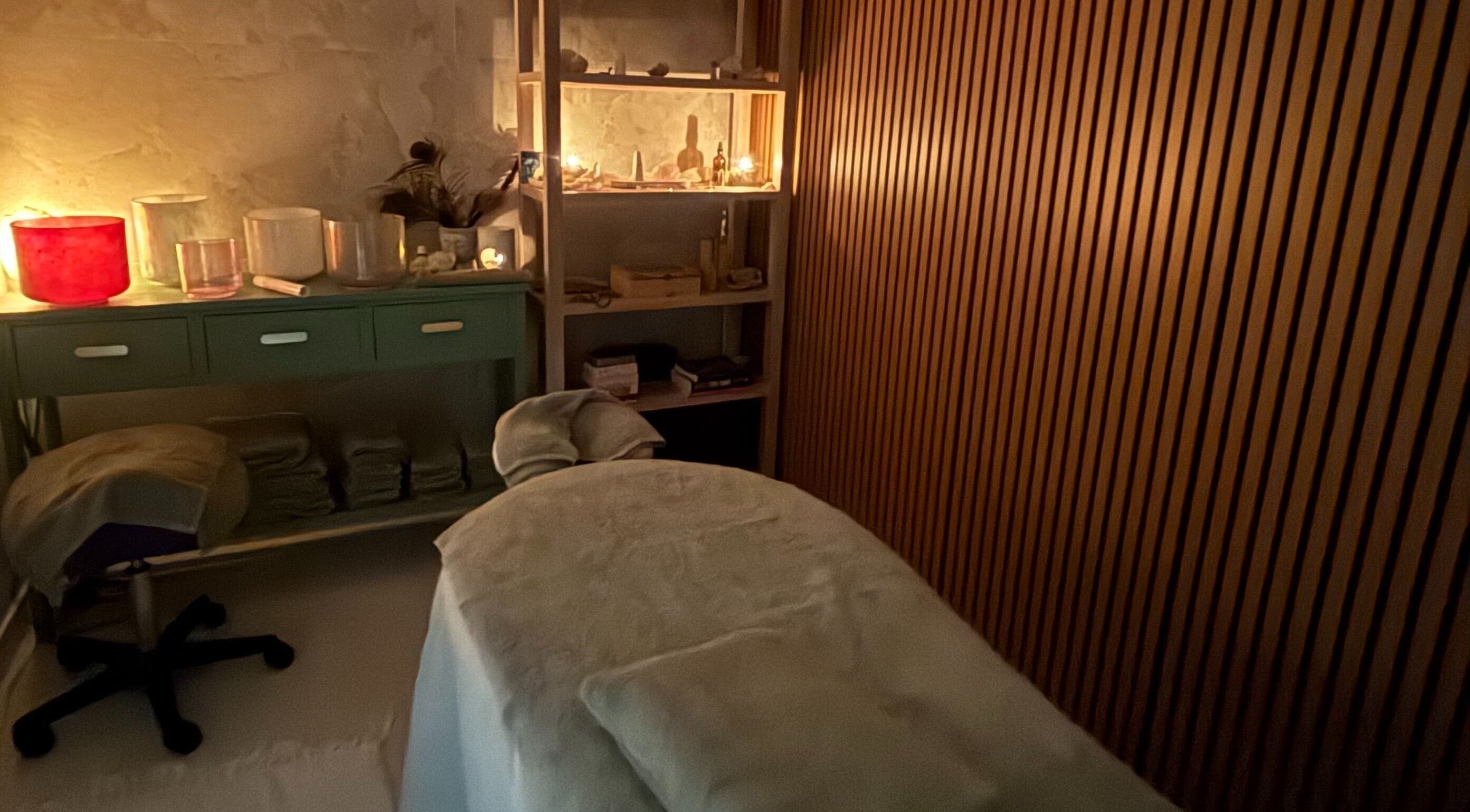 Cozy massage room ambience at The Healing Cottage, Palm Beach, Queensland, AU. Candles and soft lighting create tranquility.