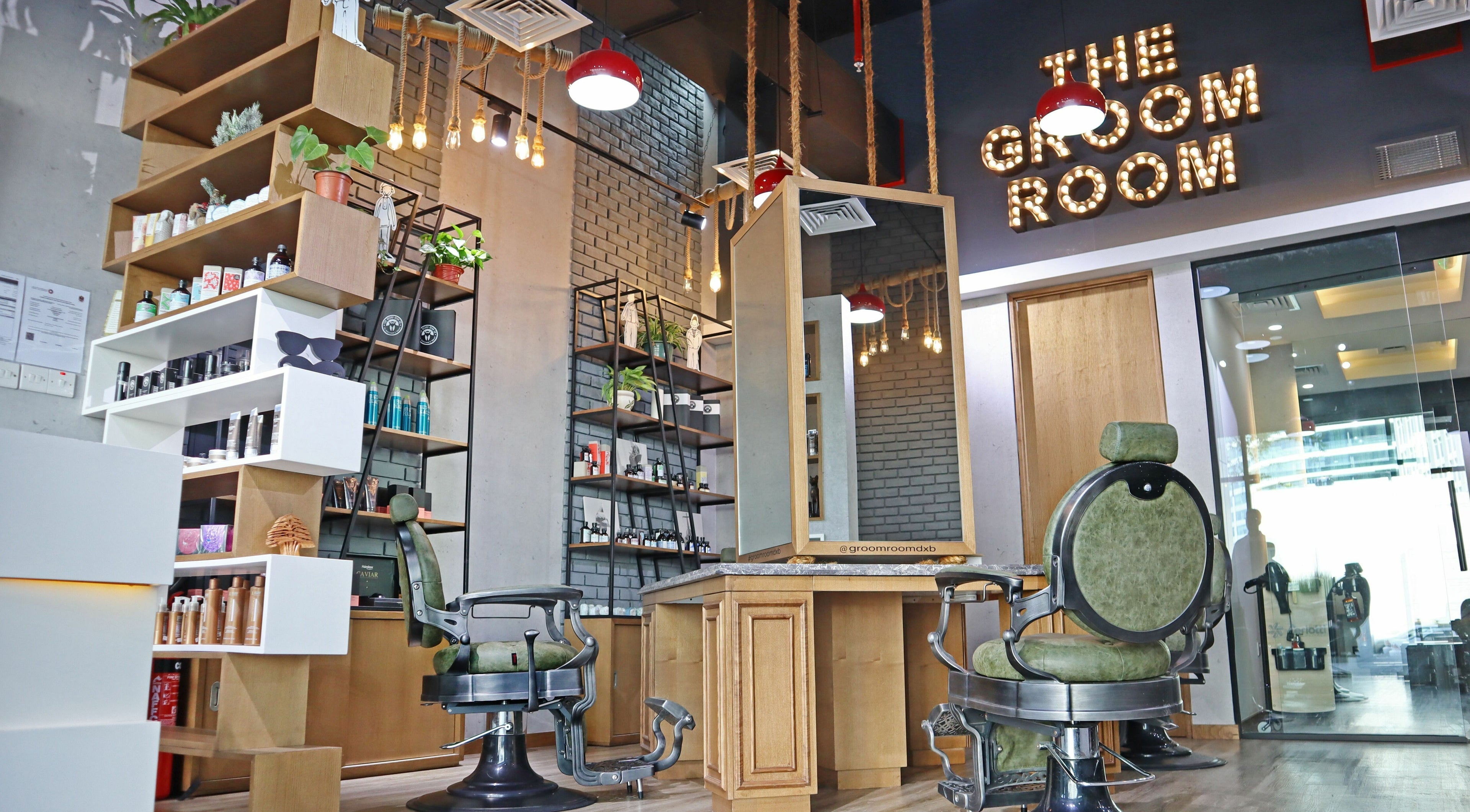 Interior of The Groom Room Gents Salon in Dubai, AE, featuring sleek barber chairs and rustic decor.