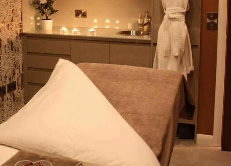 Peaceful treatment room at Beautyme in Bathgate, Scotland, GB featuring a massage bed and ambient lighting.
