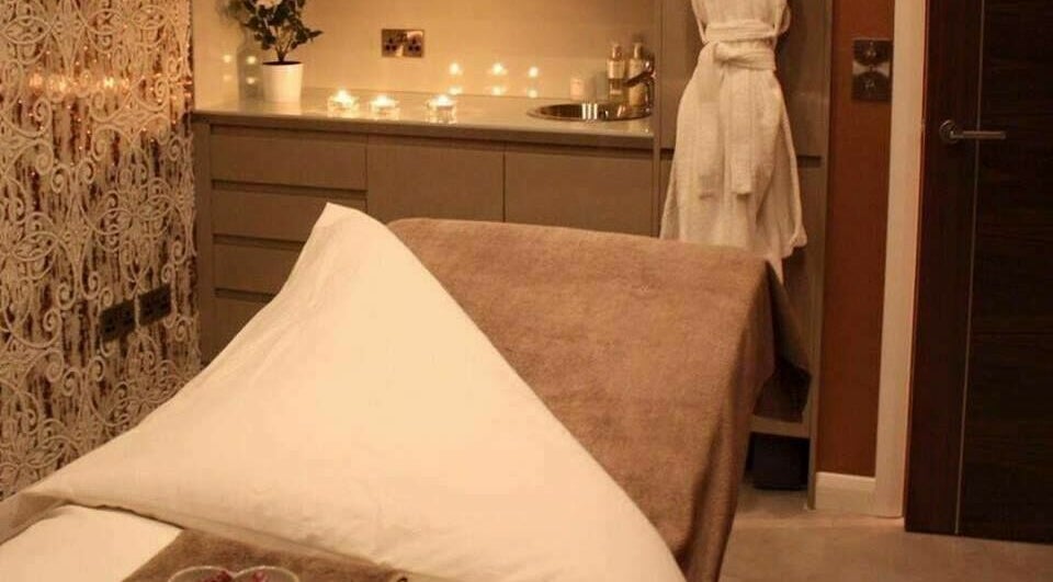 Peaceful treatment room at Beautyme in Bathgate, Scotland, GB featuring a massage bed and ambient lighting.