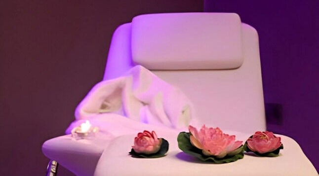 Luxurious spa chair with candles and flowers at Beautyme in Bathgate, Scotland, GB.
