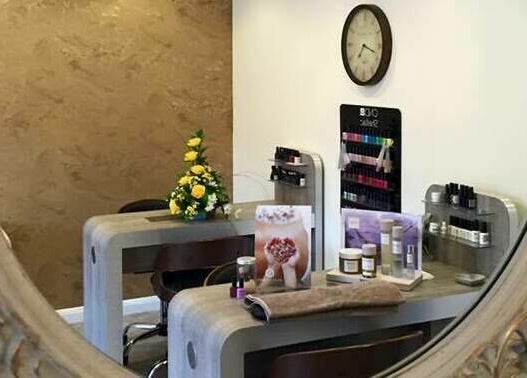 Elegant nail bar and decor at Beautyme, Bathgate, Scotland, GB viewed through ornate mirror.