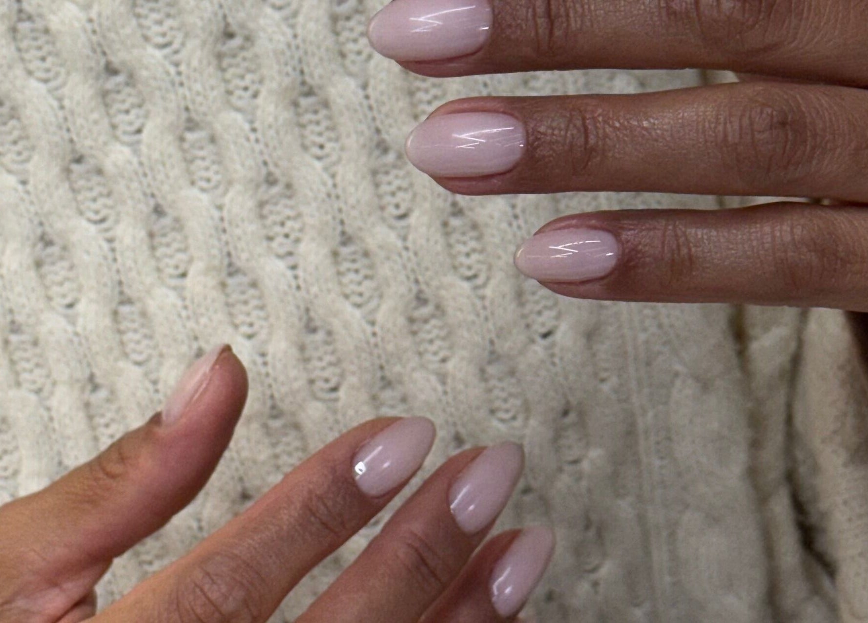 Elegant pastel manicured nails from Zegna Nails UES in New York, New York, US on a textured sweater.