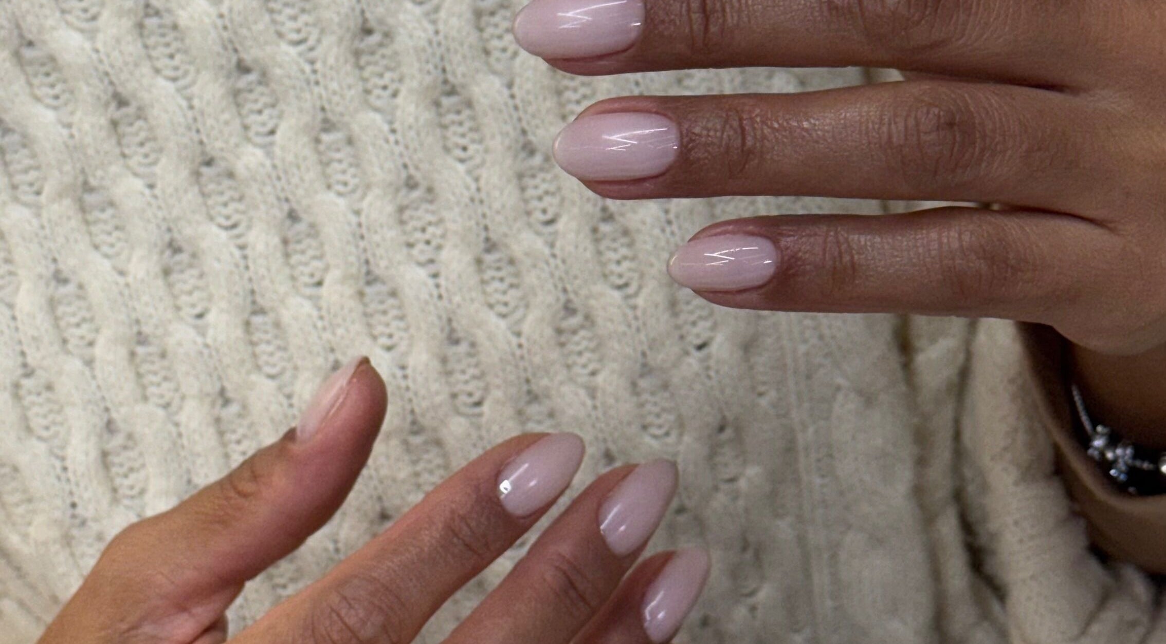 Elegant pastel manicured nails from Zegna Nails UES in New York, New York, US on a textured sweater.