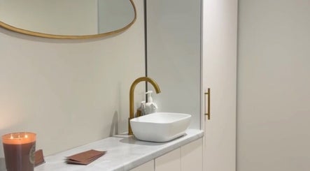 Elegant wash area at L.A Facial Aesthetics in Saltash, England, GB, featuring modern fixtures and ambient lighting.