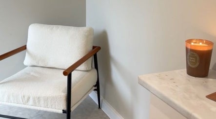 Relaxing spa chair and lit candle at L.A Facial Aesthetics, Saltash, England, GB.